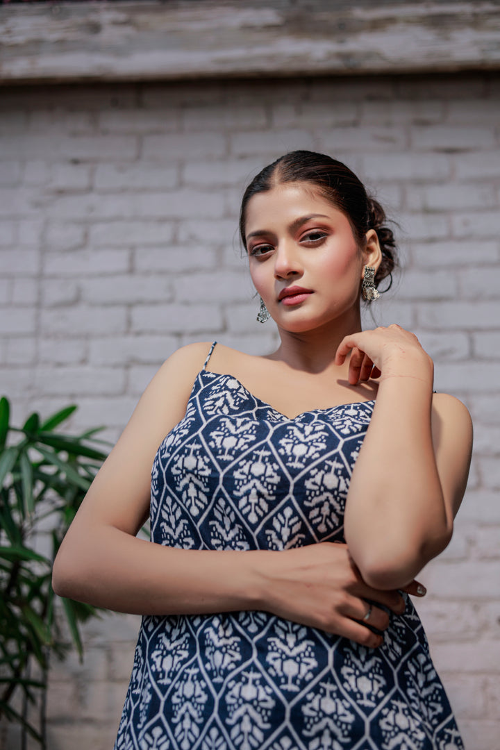 Blue printed sleeveless spaghetti strap top with white leaf-like patterns