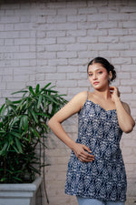 Load image into Gallery viewer, Blue printed sleeveless spaghetti strap top with white leaf-like patterns
