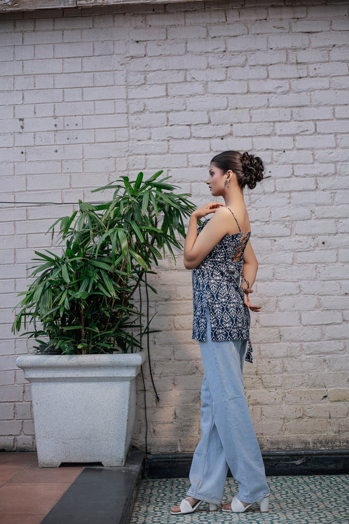 Blue printed sleeveless spaghetti strap top with white leaf-like patterns