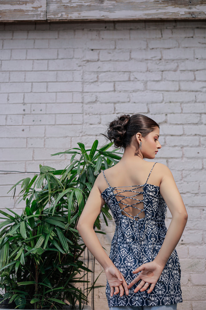 Blue printed sleeveless spaghetti strap top with white leaf-like patterns